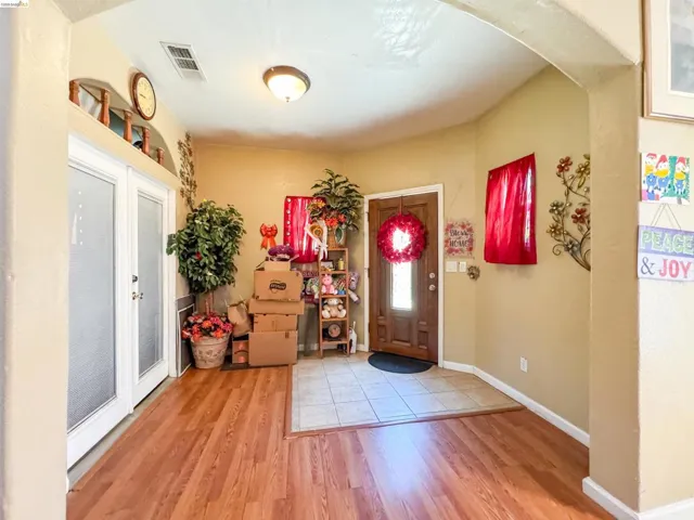 Entryway featuring wood-finish flooring and a tiled landing