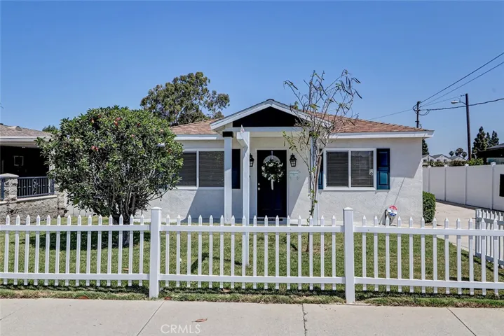 Charming at first glance with a classic white picket fence, generous front yard and your very own apple tree!