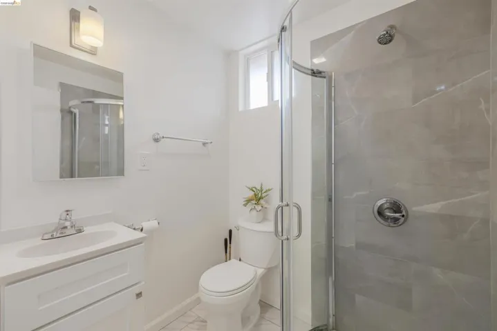 Full bathroom with vanity and a shower stall
