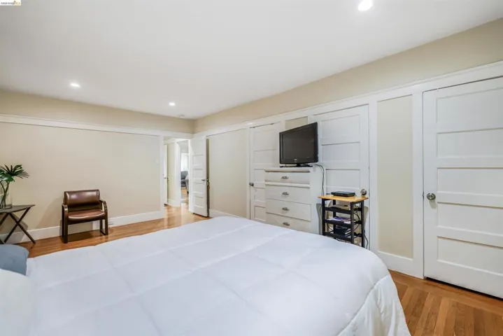 Bedroom featuring recessed lighting, light wood-style floors, and a closet