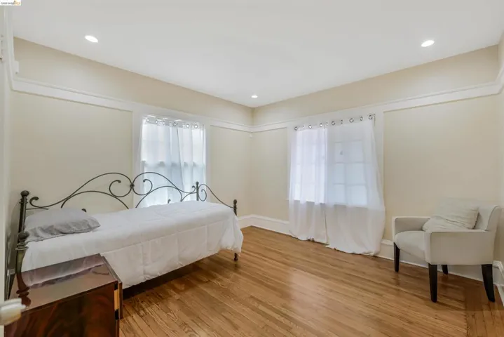 Bedroom featuring multiple windows, light wood-style floors, and recessed lighting