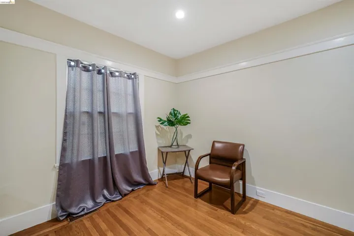 Living area with wood finished floors and recessed lighting