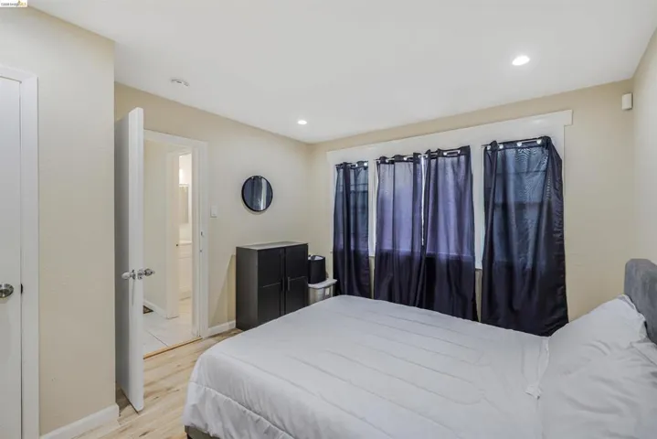 Bedroom with light wood finished floors and recessed lighting