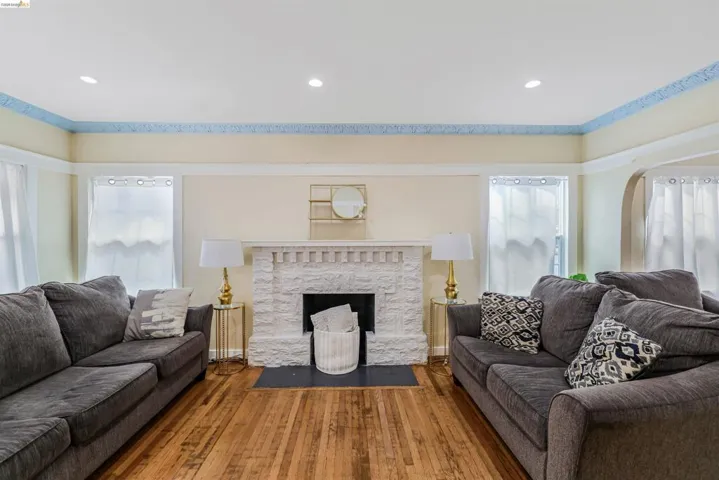 Living area featuring hardwood / wood-style flooring, recessed lighting, and a stone fireplace