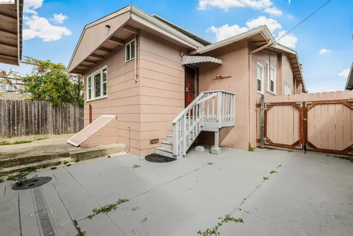 Rear view of property featuring a gate and a patio