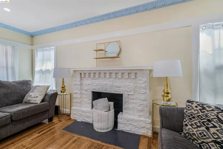Living room featuring wood-type flooring and a fireplace