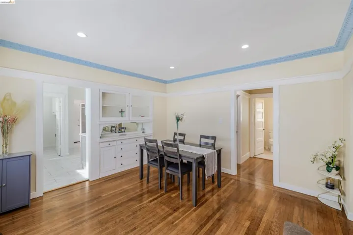 Dining room featuring light wood-style flooring, recessed lighting, and crown molding