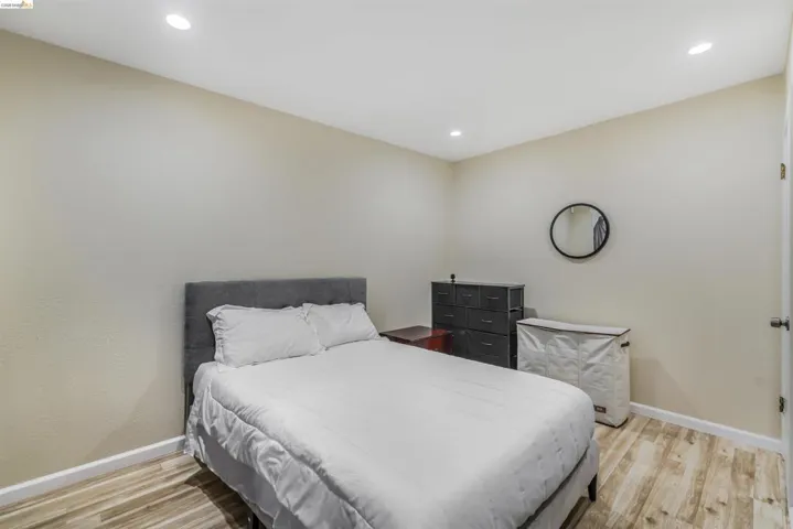 Bedroom with light wood-style flooring and recessed lighting