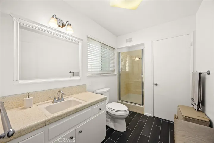 new tiled floor and frameless shower door