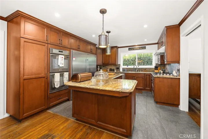 high end stainless appliances w/ side by side refrigerator