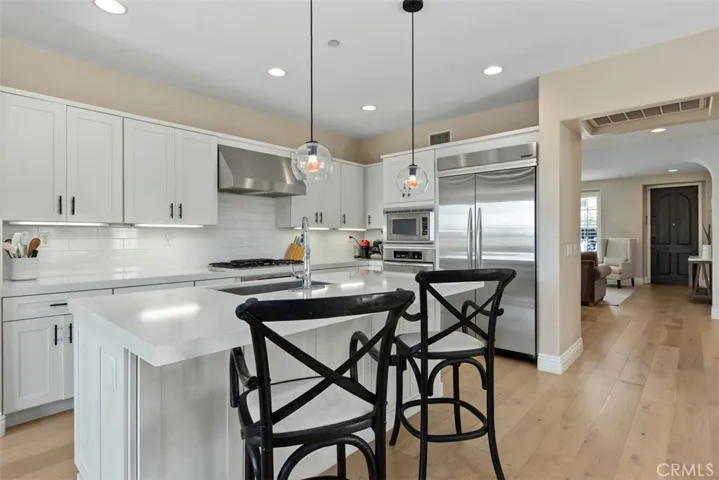 Kitchen looking towards entryway. Newer cabinets, stainless steel appliances.