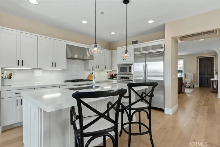 Kitchen looking towards entryway. Newer cabinets, stainless steel appliances.