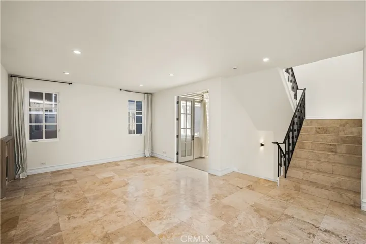 The second level serves as the main living space and features an inviting living room, dining area, and kitchen filled with natural light and ocean breezes.