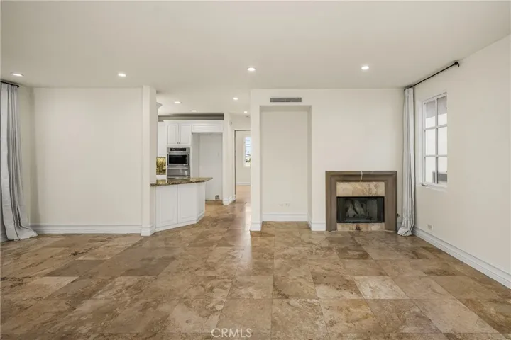 The second level serves as the main living space and features an inviting living room, dining area, and kitchen filled with natural light and ocean breezes.