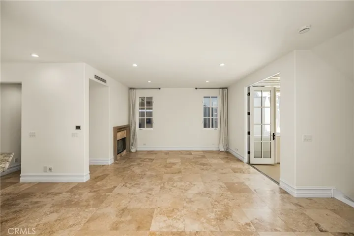 The second level serves as the main living space and features an inviting living room, dining area, and kitchen filled with natural light and ocean breezes.