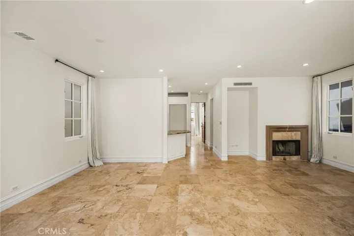 The second level serves as the main living space and features an inviting living room, dining area, and kitchen filled with natural light and ocean breezes.