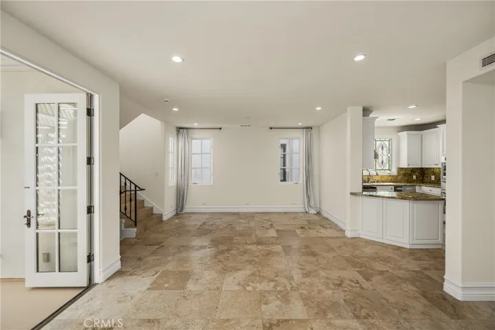 The second level serves as the main living space and features an inviting living room, dining area, and kitchen filled with natural light and ocean breezes.