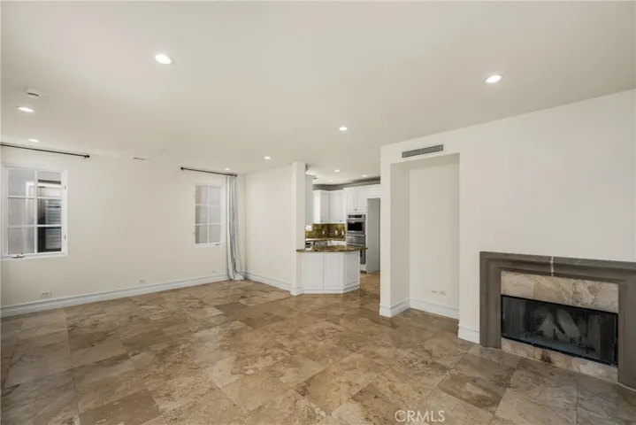 The second level serves as the main living space and features an inviting living room, dining area, and kitchen filled with natural light and ocean breezes.