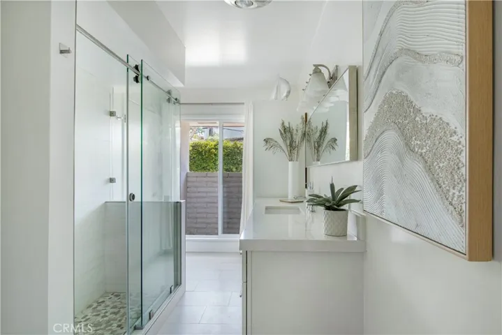 Large guest bathroom with glass sliding door walk-in-shower.