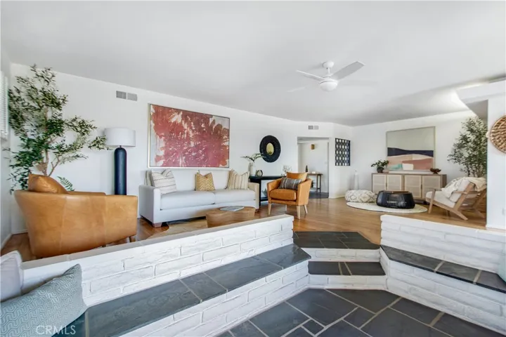 View from fireplace sitting area towards living room, front entry and sitting area.