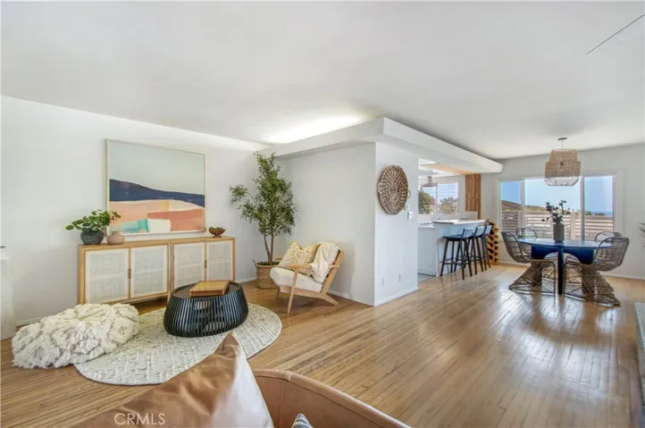 View of sitting area, dining area, breakfast bar and kitchen from living room.