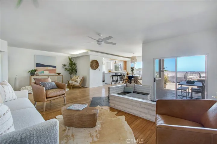 View from living room towards sitting area, kitchen including breakfast bar, dining area and fireplace sitting area.