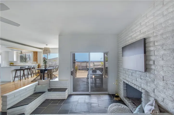 Fireplace sitting area, slider to back side covered patio.