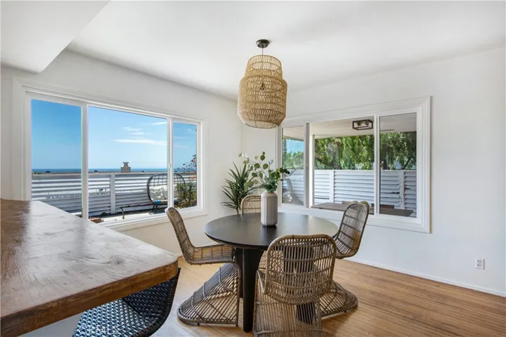 View from kitchen into dining area and in the backdrop view of ocean!