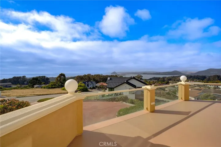 View from deck of ocean, dunes, mountains and Morro Bay rock plus Baywood