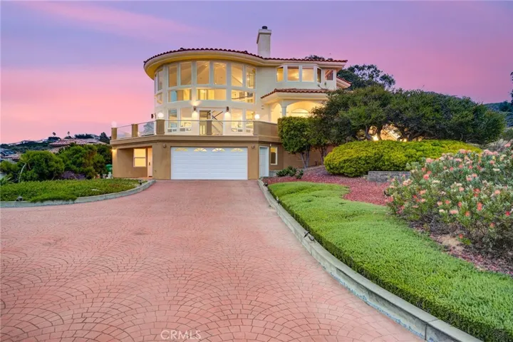 driveway to front of home with 2 car garage