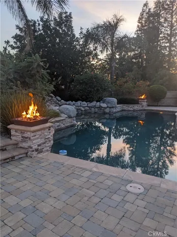 Night View Of Pool With Fire Bowls