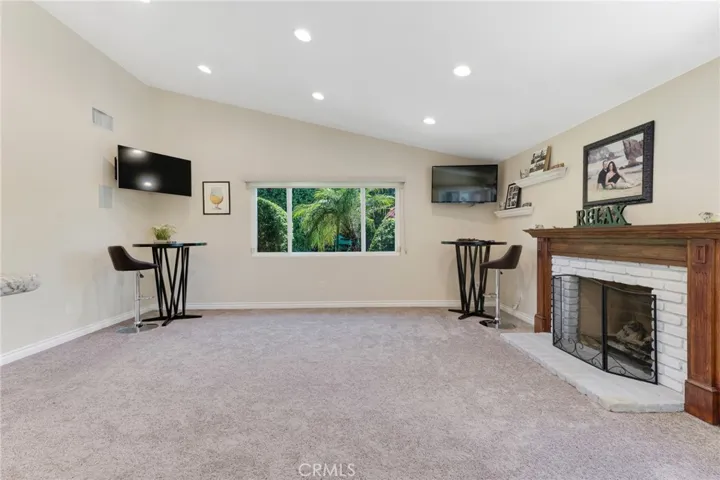 Family Room With Vaulted Ceiling & Cozy Fireplace