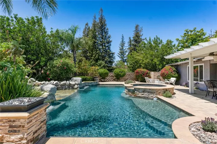 Pool With "California Shelves" With Umbrella Holders In The Shallow End And In Front Of The Water Fall.