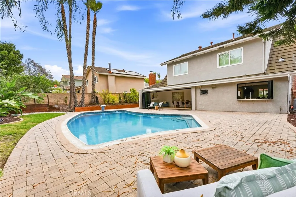 Large Private Summer Ready Backyard with a pool that has a Diving Board