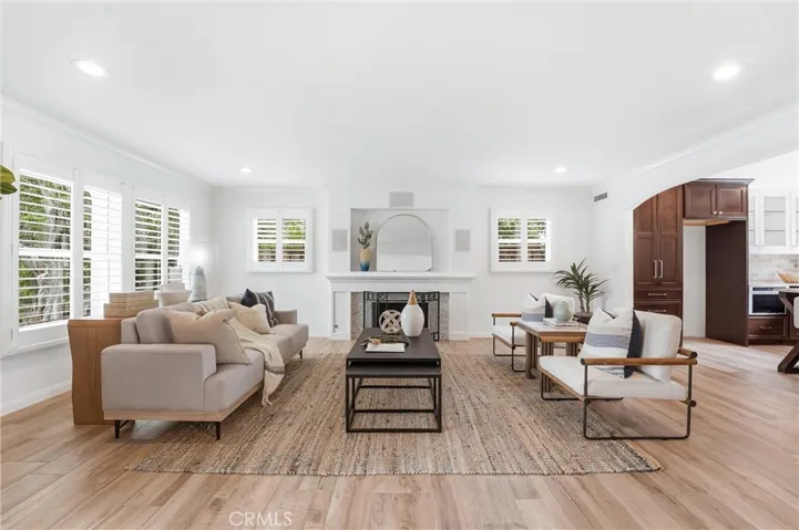 Formal Living Room with Fireplace, Recessed Lighting and Custom Window Shutters