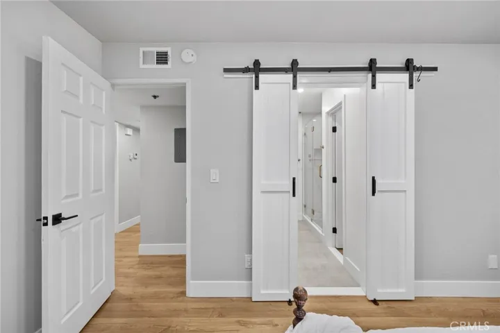 Primary bedroom barn doors leading into bathroom