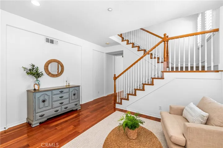 A charming light-filled welcome lounge greets you upon entry, featuring wood flooring, bright white interior, plantation shutters and beautiful wall-to-wall windows.