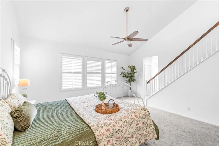 The expansive primary suite offers soaring ceilings, dramatic wall-to-wall windows, a unique upper loft retreat, spa-inspired bath with soaking tub, dual vanities, a linen closet, and a walk-in closet.