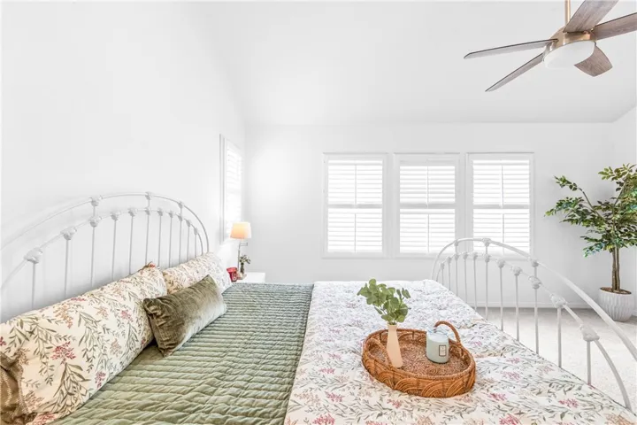 The expansive primary suite offers soaring ceilings, dramatic wall-to-wall windows, a unique upper loft retreat, spa-inspired bath with soaking tub, dual vanities, a linen closet, and a walk-in closet.