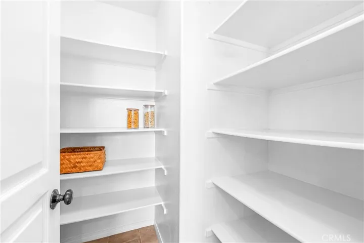 Spacious and beautifully connected to the living areas, the kitchen features a generous breakfast nook, center island with seating and storage, abundant cabinetry, walk -in pantry, and sunlit backyard views.