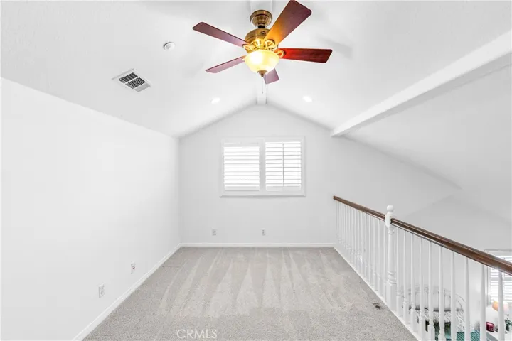 The expansive primary suite offers soaring ceilings, dramatic wall-to-wall windows, a unique upper loft retreat, spa-inspired bath with soaking tub, dual vanities, a linen closet, and a walk-in closet.