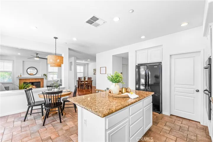 Spacious and beautifully connected to the living areas, the kitchen features a generous breakfast nook, center island with seating and storage, abundant cabinetry, walk -in pantry, and sunlit backyard views.