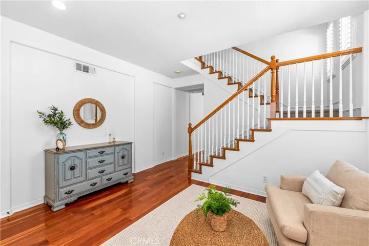 A charming light-filled welcome lounge greets you upon entry, featuring wood flooring, bright white interior, plantation shutters and beautiful wall-to-wall windows.