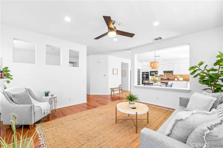 Designed for seamless everyday living and entertaining, the expansive great room flows effortlessly into the kitchen, dining, and breakfast areas with rich wood floors, recessed lighting, a cozy fireplace, and wall-to-wall windows.