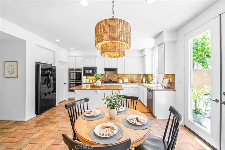 Spacious and beautifully connected to the living areas, the kitchen features a generous breakfast nook, center island with seating and storage, abundant cabinetry, walk -in pantry, and sunlit backyard views.