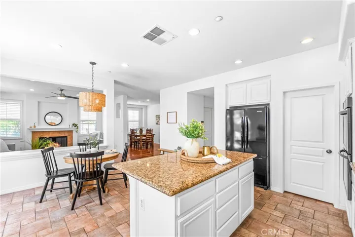 Spacious and beautifully connected to the living areas, the kitchen features a generous breakfast nook, center island with seating and storage, abundant cabinetry, walk -in pantry, and sunlit backyard views.