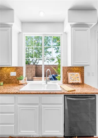 Spacious and beautifully connected to the living areas, the kitchen features a generous breakfast nook, center island with seating and storage, abundant cabinetry, walk -in pantry, and sunlit backyard views.