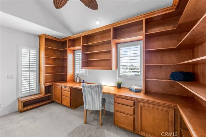 A stunning light -filled mezzanine retreat awaits at the top of t he stairs, featuring a wall-to-wall custom library office with wrap around built-ins, and an elevated loft space perfect for a studio, reading nook, gym or 5th bedroom.