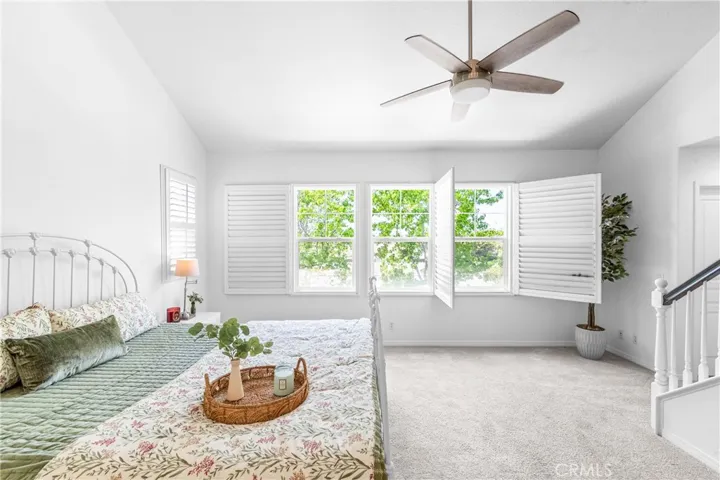 The expansive primary suite offers soaring ceilings, dramatic wall-to-wall windows, a unique upper loft retreat, spa-inspired bath with soaking tub, dual vanities, a linen closet, and a walk-in closet.
