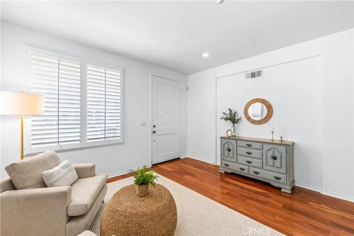A charming light-filled welcome lounge greets you upon entry, featuring wood flooring, bright white interior, plantation shutters and beautiful wall-to-wall windows.